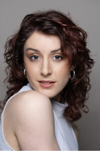 Relaxed studio portrait of woman with styled hair and soft makeup, Blouberg
