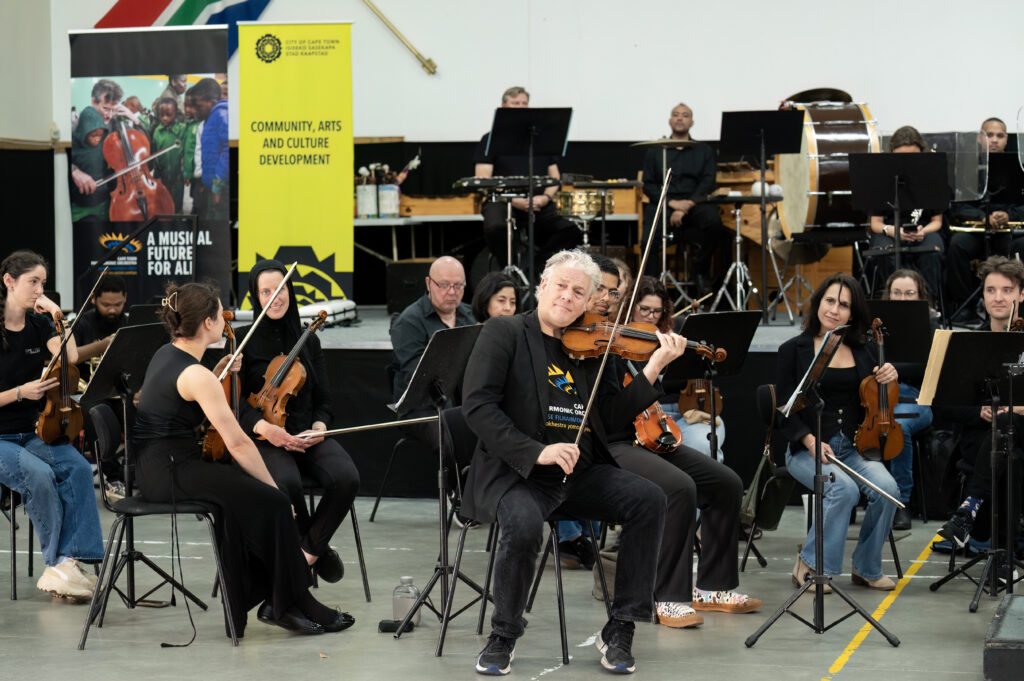 Orchestra and violinist performing at a cultural event in Cape Town
