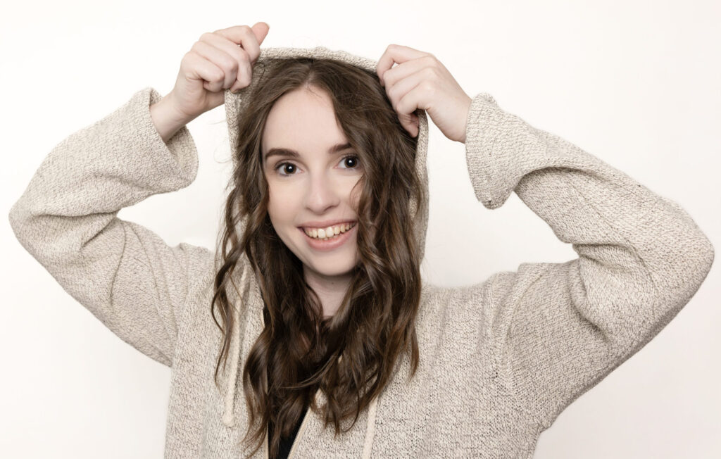 Model wearing a cream knitted garment in a styled product photograph